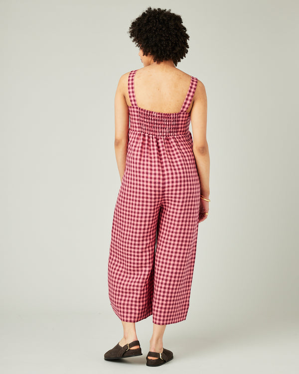 pregnant model wears blush gingham linen cari jumpsuit