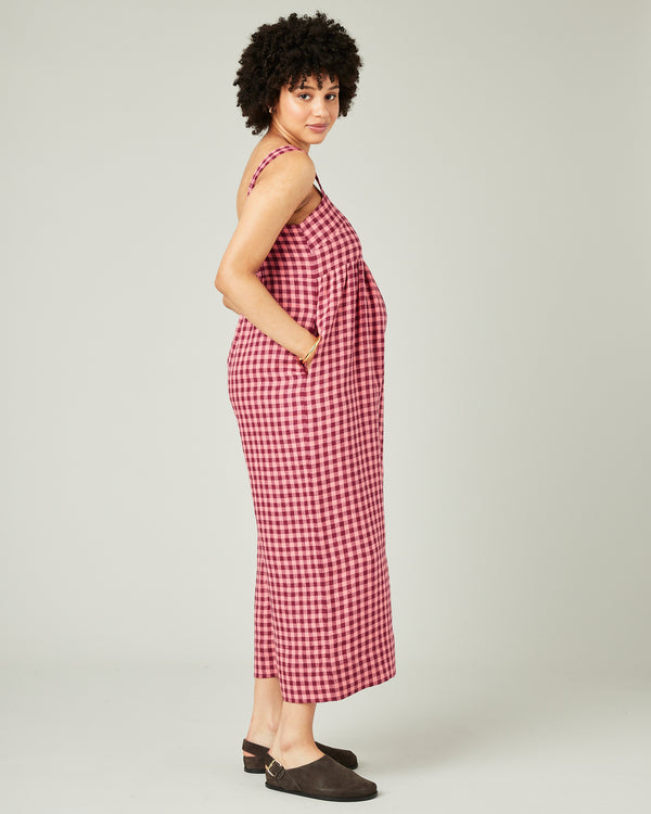 pregnant model wears blush gingham linen cari jumpsuit