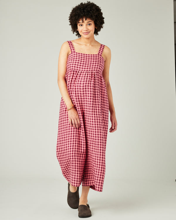 pregnant model wears blush gingham linen cari jumpsuit
