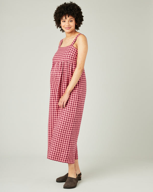pregnant model wears blush gingham linen cari jumpsuit