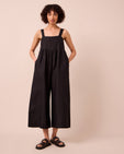 model wears cari black linen jumpsuit