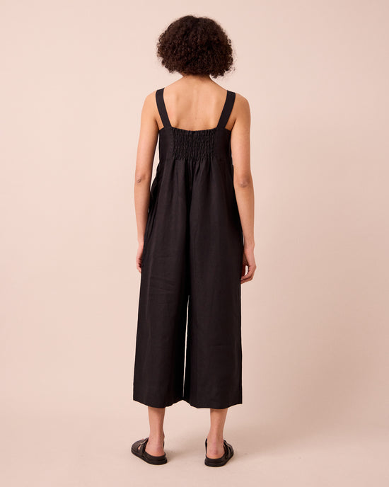 model wears cari black linen jumpsuit