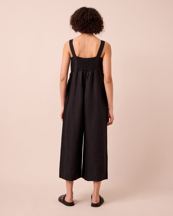 model wears cari black linen jumpsuit