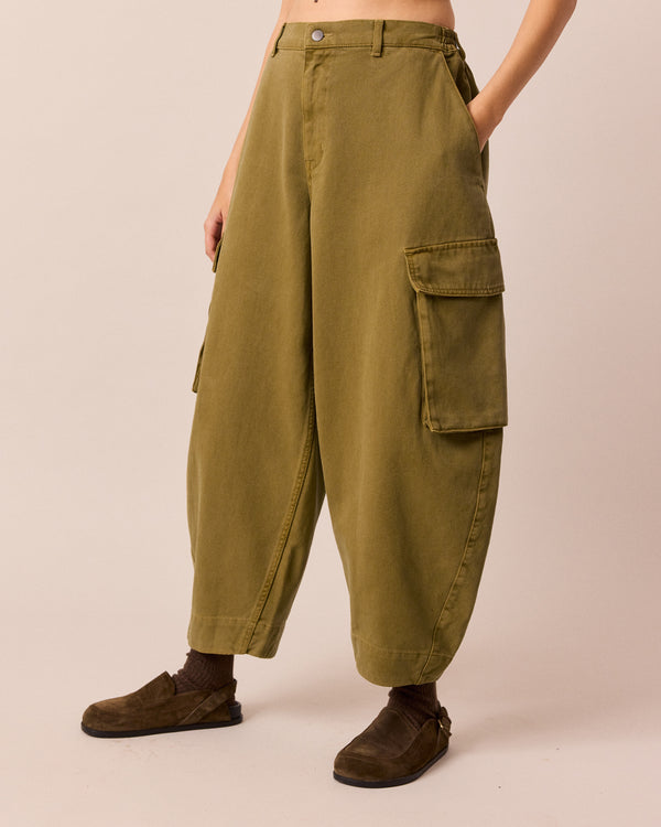 model wears claudie bronzed hay denim jeans left