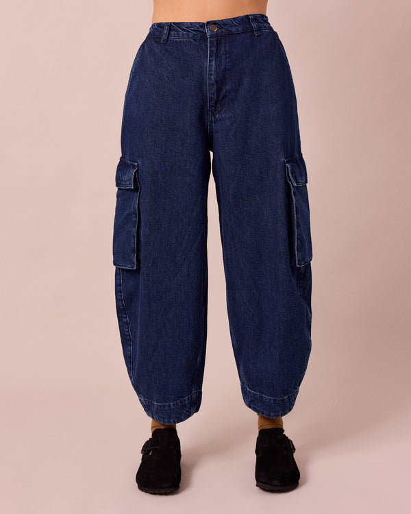 model wears claudie dark blue denim jeans front