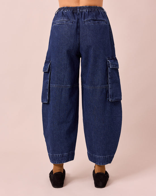 model wears claudie dark blue denim jeans back