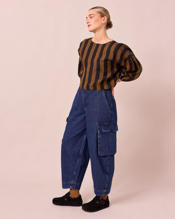 model wears claudie dark blue denim jeans left