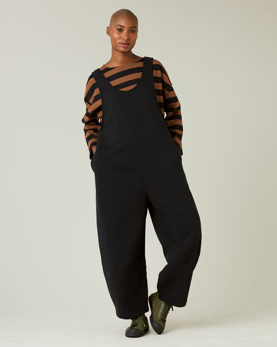 model wears black jersey clover jumpsuit