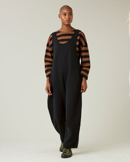 model wears black jersey clover jumpsuit