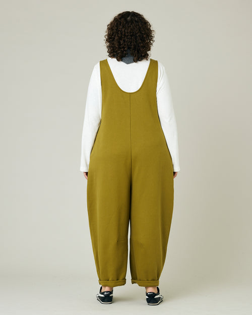 model wears golden olive jersey clover jumpsuit