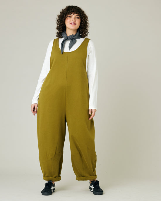 model wears golden olive jersey clover jumpsuit