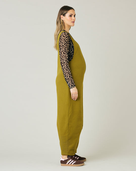 pregnant model wears golden olive jersey clover jumpsuit