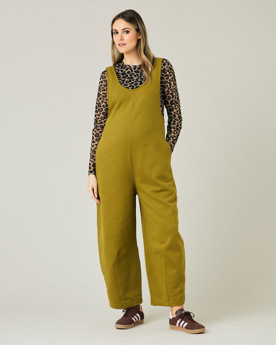 pregnant model wears golden olive jersey clover jumpsuit