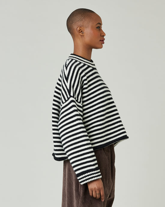 model wears black and ivory stripe coco