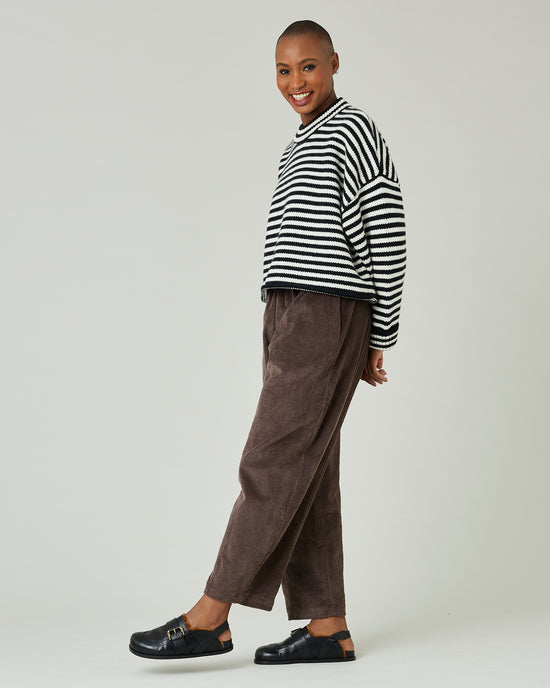 model wears black and ivory stripe coco