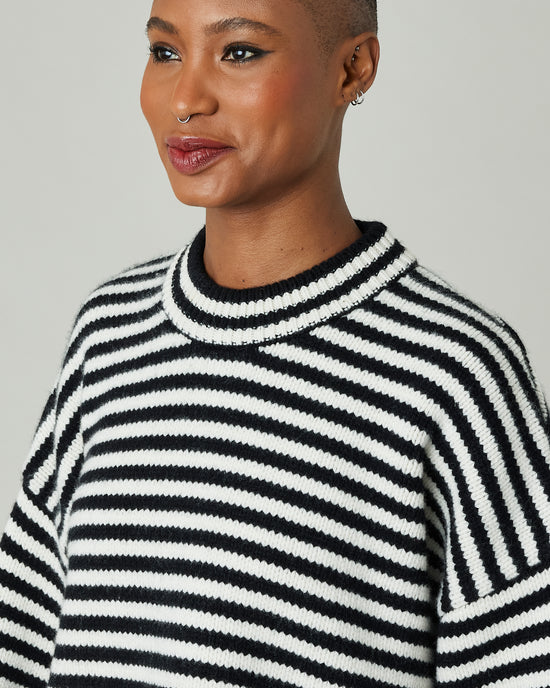 model wears black and ivory stripe coco