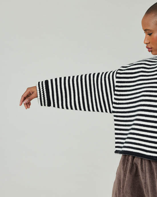 model wears black and ivory stripe coco