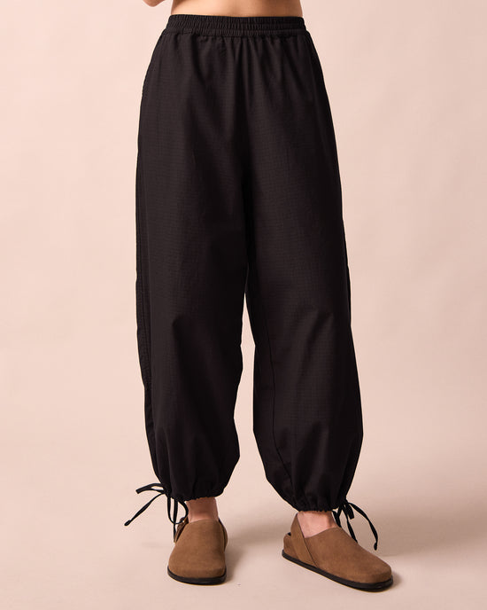 model wears codi black textured cotton trousers front