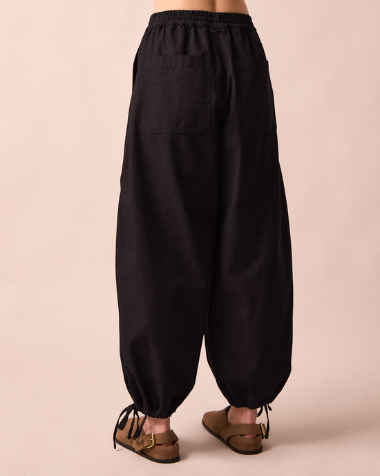 model wears codi black textured cotton trousers back