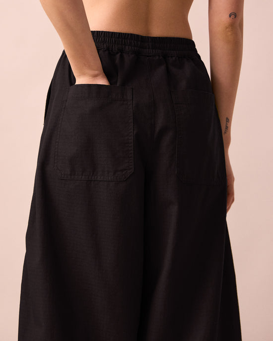 model wears codi black textured cotton trousers detail