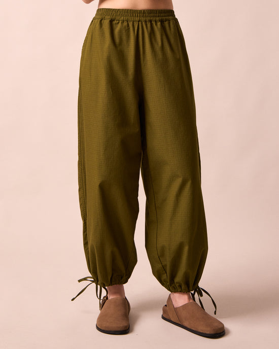 model wears codi dark olive textured cotton trousers front