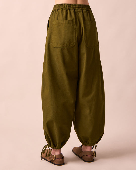 model wears codi dark olive textured cotton trousers back