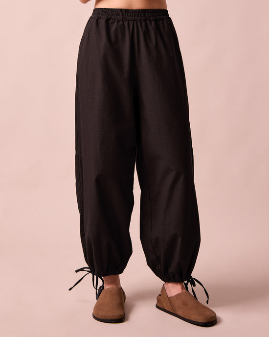 model wears codi black textured cotton trousers front