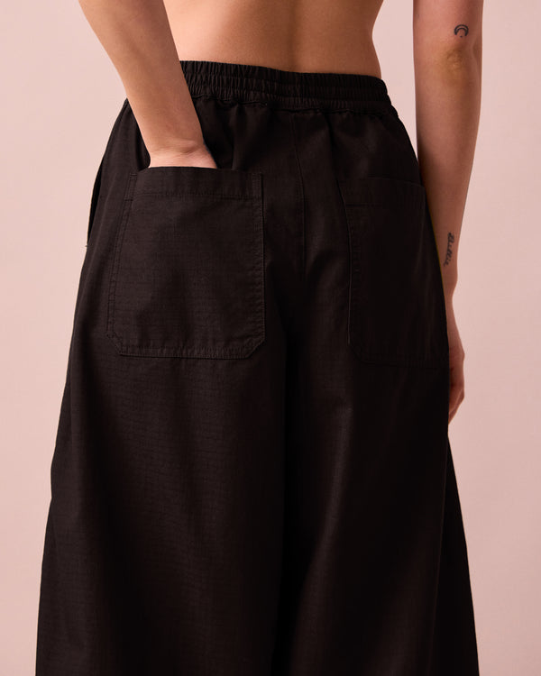 model wears codi black textured cotton trousers