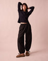 model wears codi black textured cotton trousers left