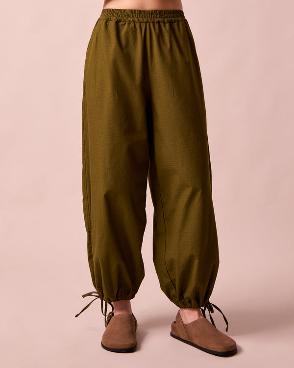 model wears codi dark olive textured cotton trousers front
