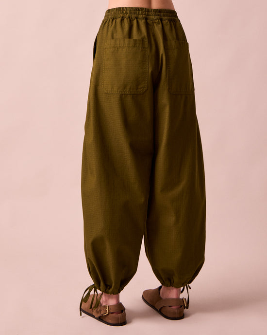 model wears codi dark olive textured cotton trousers back