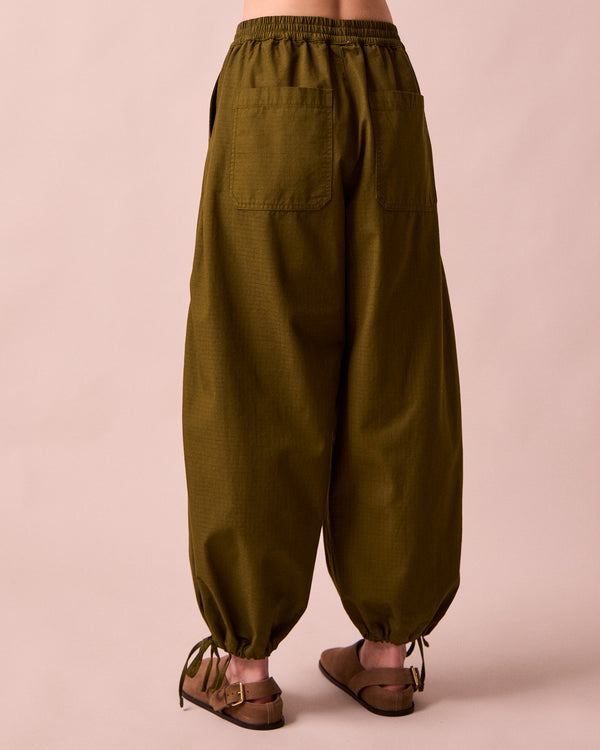 model wears codi dark olive textured cotton trousers back