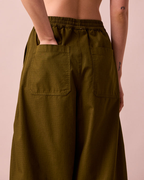model wears codi dark olive textured cotton trousers