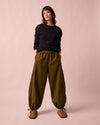 model wears codi dark olive textured cotton trousers right