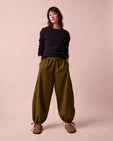 model wears codi dark olive textured cotton trousers right