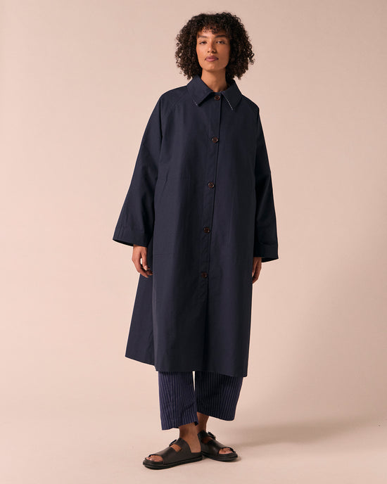 model wears collette navy coated cotton trench coat