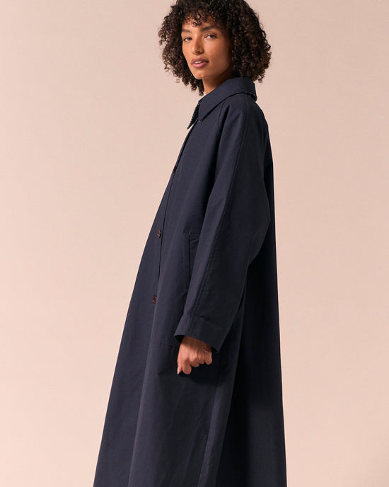 model wears collette navy coated cotton trench coat