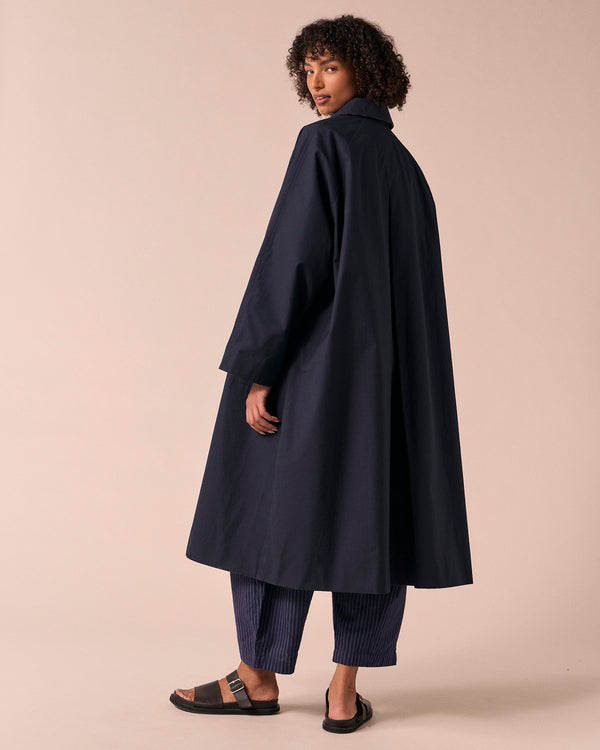 model wears collette navy coated cotton trench coat