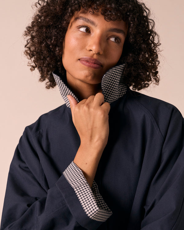 model wears collette navy coated cotton trench coat