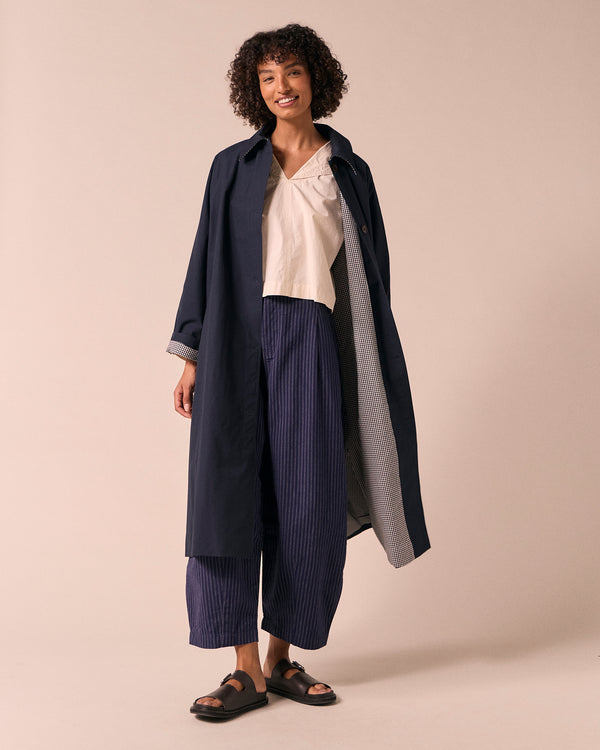 model wears collette navy coated cotton trench coat