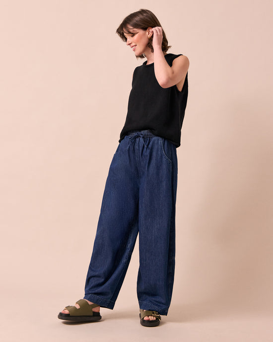 model wears cora dark wash denim jeans left