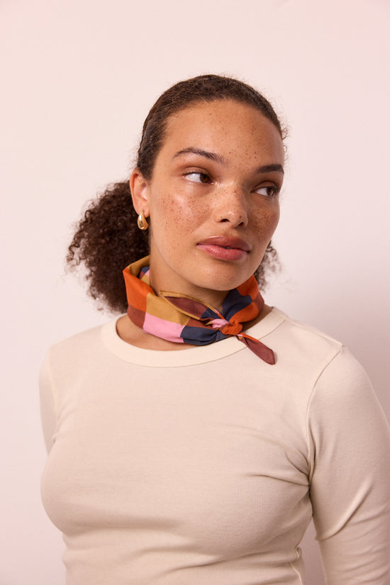model wears neckerchief sunset harlequin neckerchief