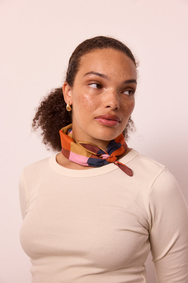 model wears neckerchief sunset harlequin neckerchief