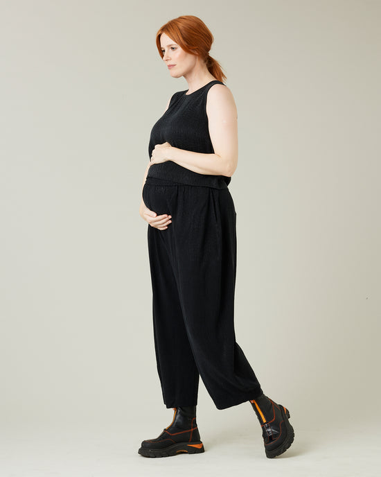 pregnant model wears black self leopard cupro mabel trousers