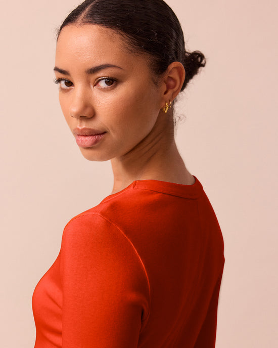 model wears lila red jersey top