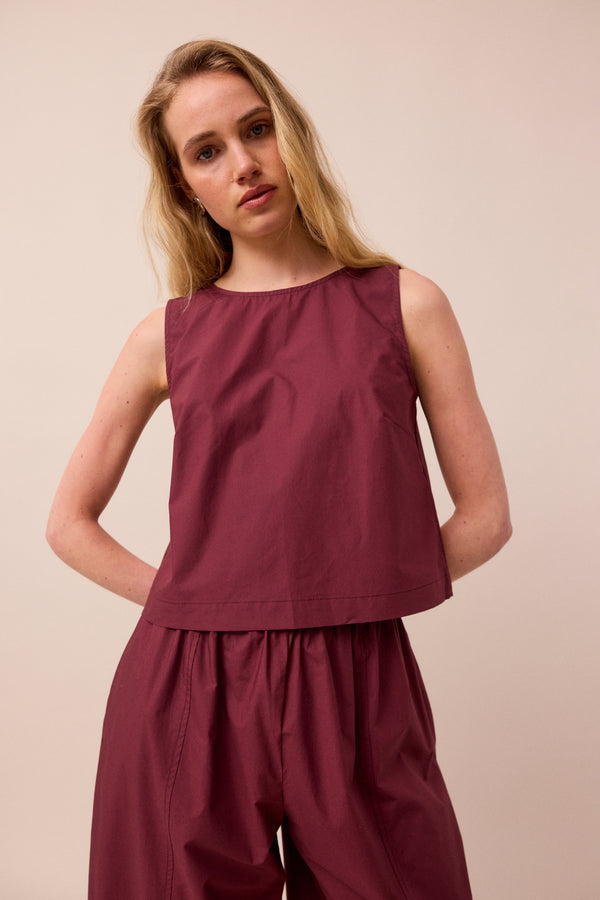 model wears esme burgundy poplin top