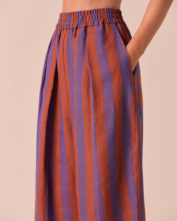 model wears bobbi terracotta stripe linen trousers right