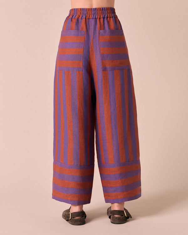 model wears bobbi terracotta stripe linen trousers back