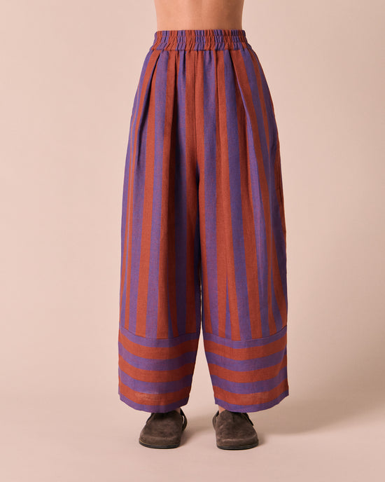 model wears bobbi terracotta stripe linen trousers front