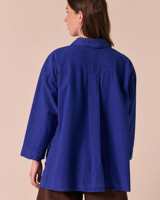 model wears edith klein blue cotton popolin shirt